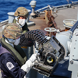A Royal Navy Weapons Maintainer prepares the belt feed for the 30mm gun.